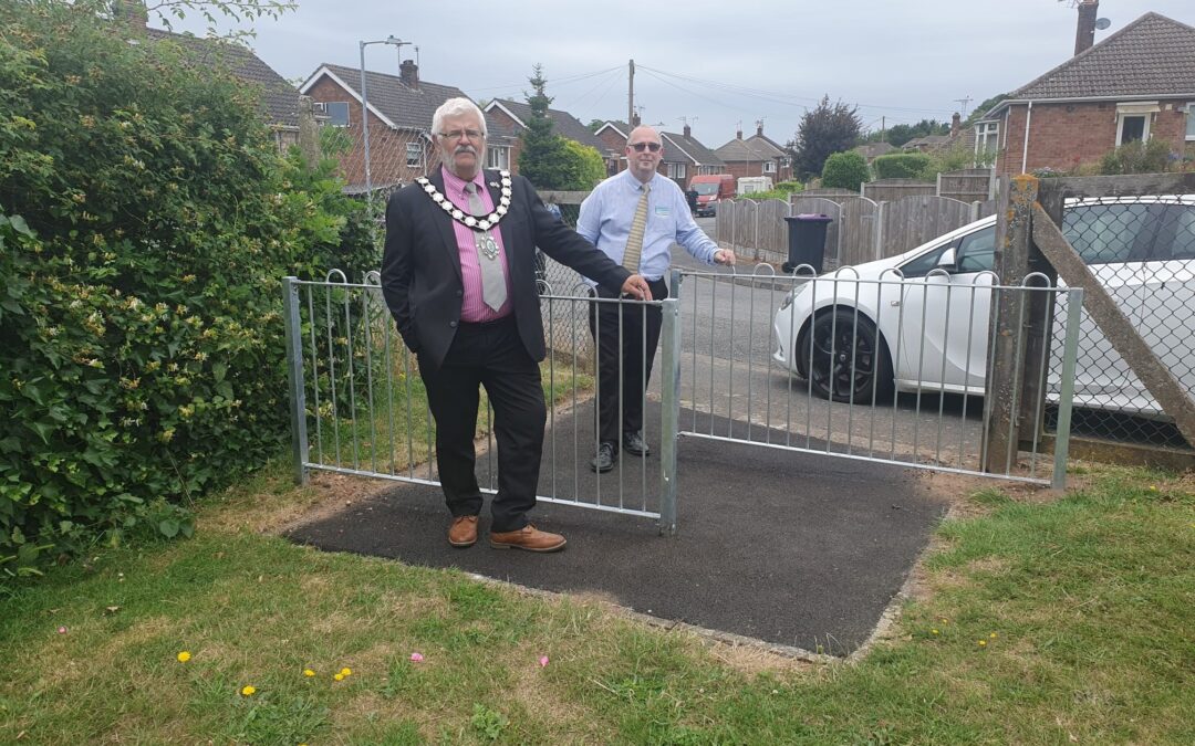 Mayor Cllr Tim Davies and Leader of the Council Cllr Richard Craig standing with the new staggered safety railings.