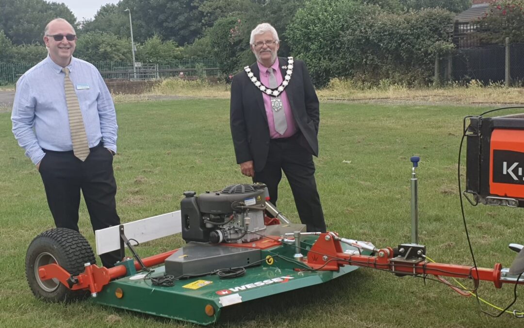 Photo of Mayor Cllr Tim Davies and Council Leader Cllr Craig stood at the back of the Wessex Mower