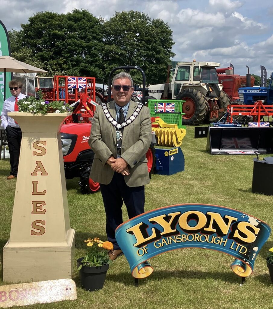Mayor of Gainsborough Cllr Kenneth Woolley stood next to the Lyons of Gainsborough Ltd sign
