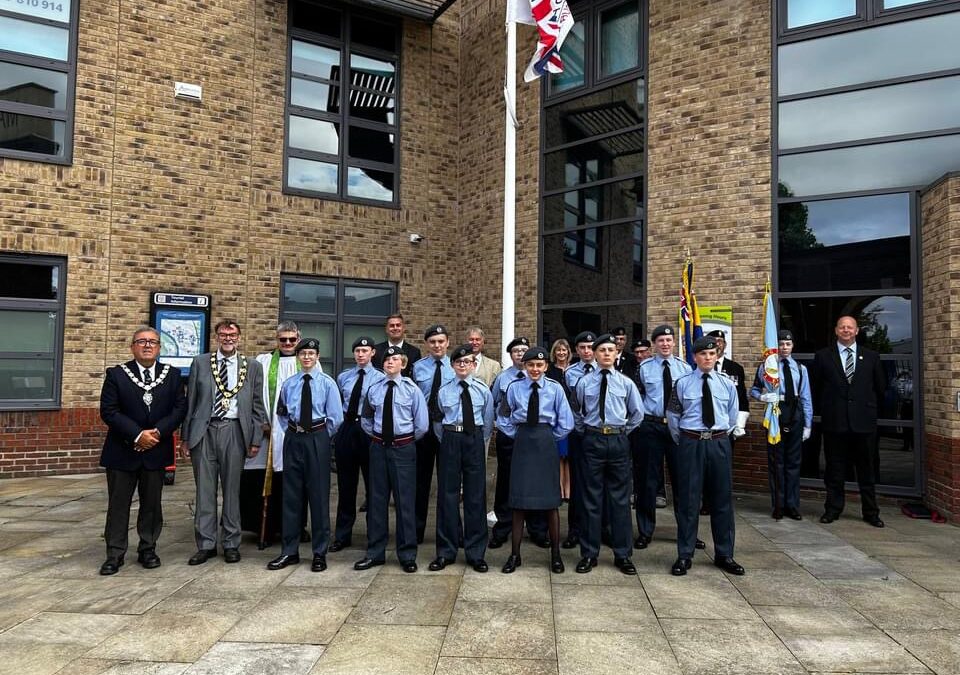 Civic heads, Air Cadets and WLDC staff stood next to a flag pole commemorating Armed Forces Day