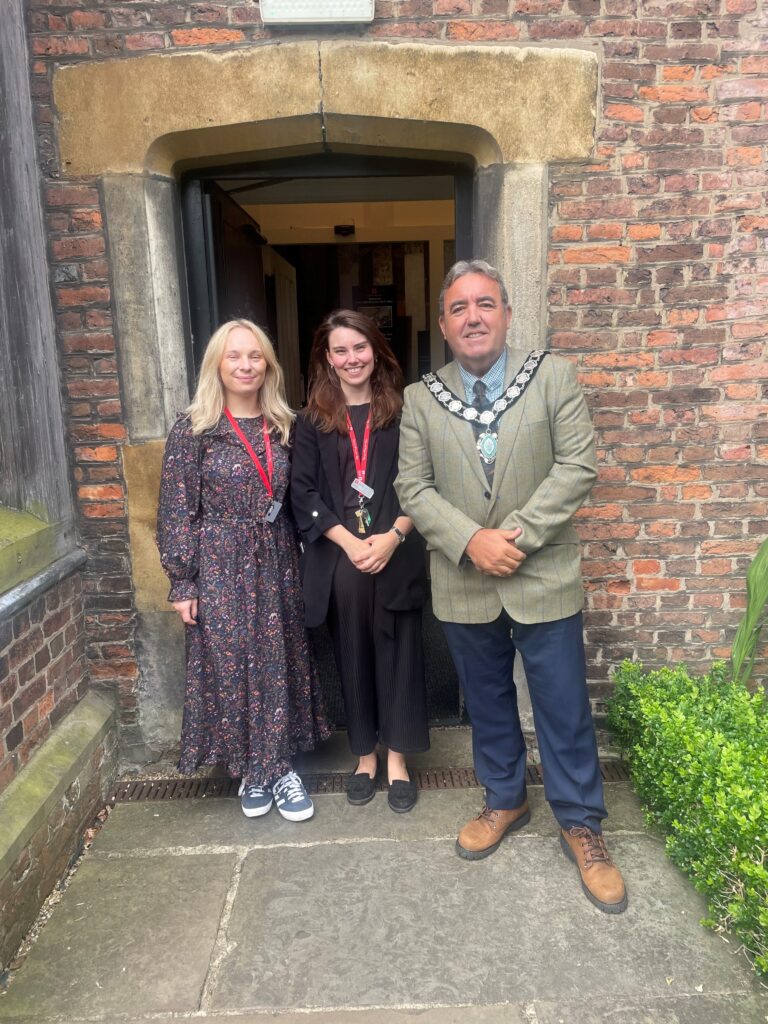 Cllr Woolley stood in the doorway with members of the Gainsborough Old Hall team.